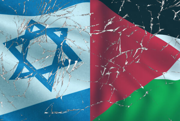 The Israeli flag and Palestinian flags side by side with a broken glass motif in front of them.