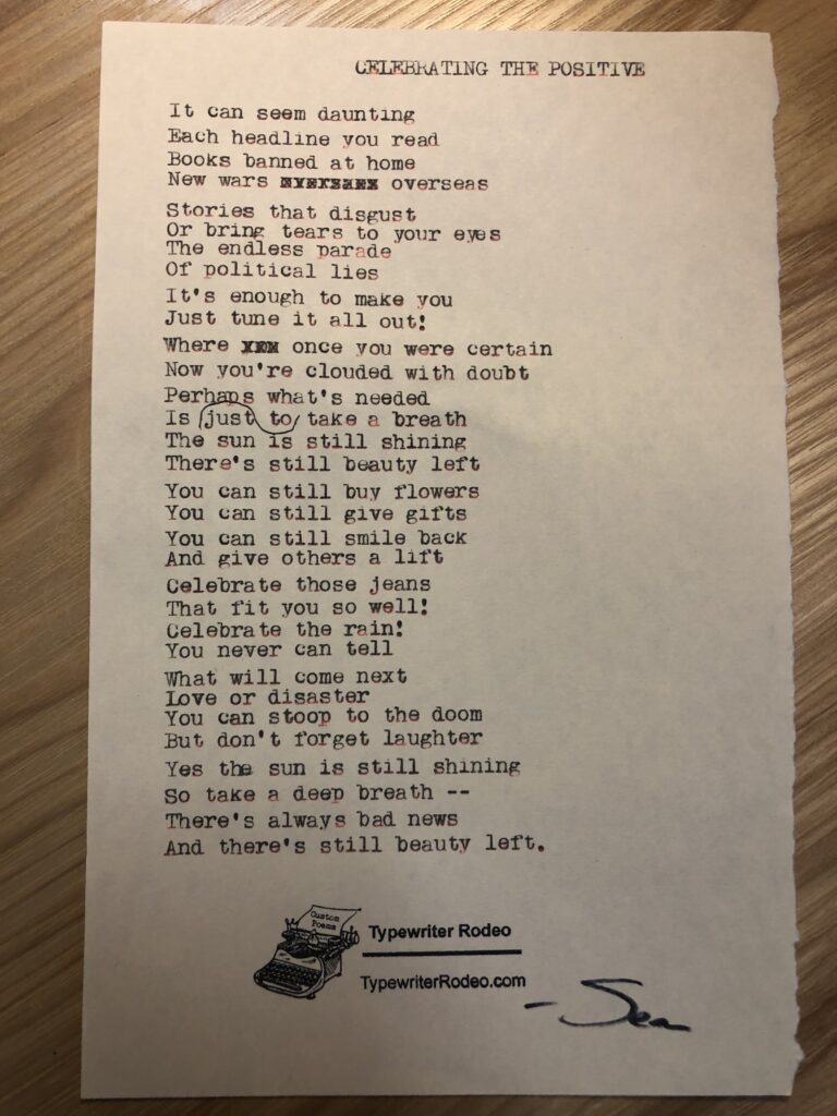 a photo of the typewritten poem on a torn half sheet of yellowish paper.