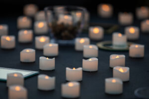 Small candles glow in the dark.