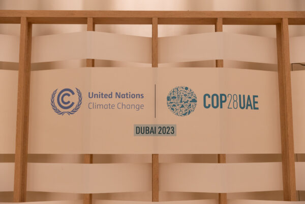 Blue logos on a white wall read "United Nations Climate Change," "COP28UAE" and "Dubai 2023"