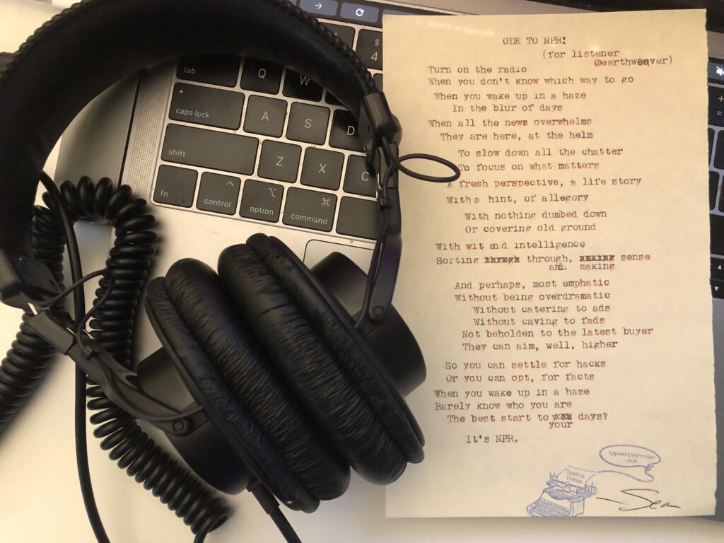 a photo of the typewritten poem on a torn half sheet of light yellow paper. the paper rests on a laptop keyboard with a pair of headphones next to it.