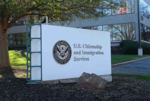 A sign outside a building says "U.S. Citizenship and Immigration Services"