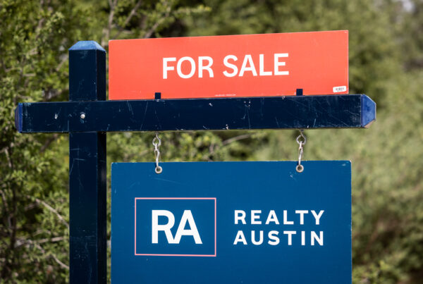 A sign outside a home says "for sale / Realty Austin"
