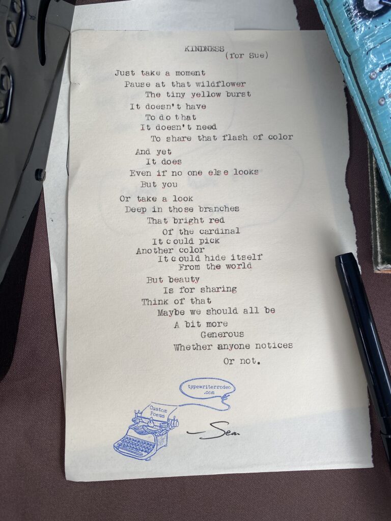 A photo of the typewritten poem on a torn half sheet of light yellow paper.