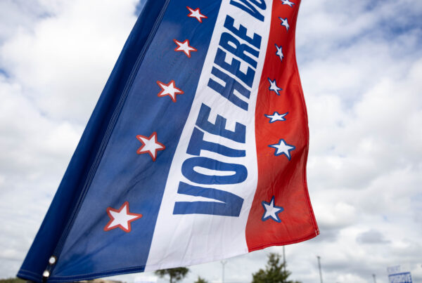 A red white and blue flag outside that says "Vote Here"