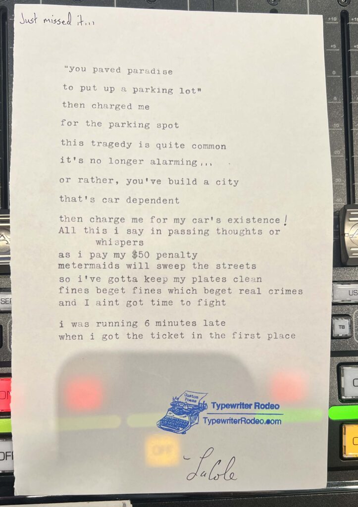 A photo of the typewritten poem on a torn half-sheet of light yellow paper.