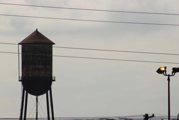 A water tower behind power lines