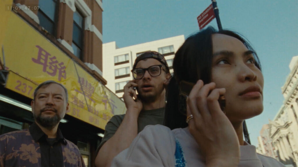 Two people are on their cell phones in a still image from the film "Mam."