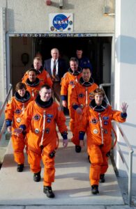STS-114 Commander Eileen Collins leads the way as the next Space Shuttle crew does a practice walkout from the Operations and Checkout Building.