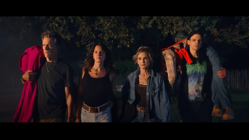 Kevin Bacon, Kyra Sedgwick and two of their children in a nighttime still image from the film "Family Movie."