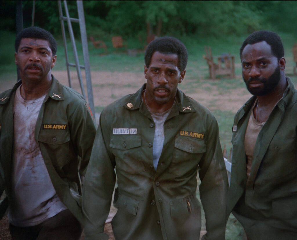 A screenshot shows three Black men in dirty U.S. Army uniforms.