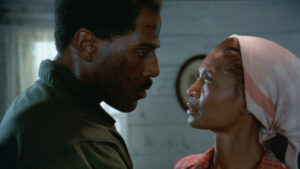 A screenshot from the 6k restoration of the film "Riverbend" shows Steve James, left, and Margaret Avery in a close conversation.
