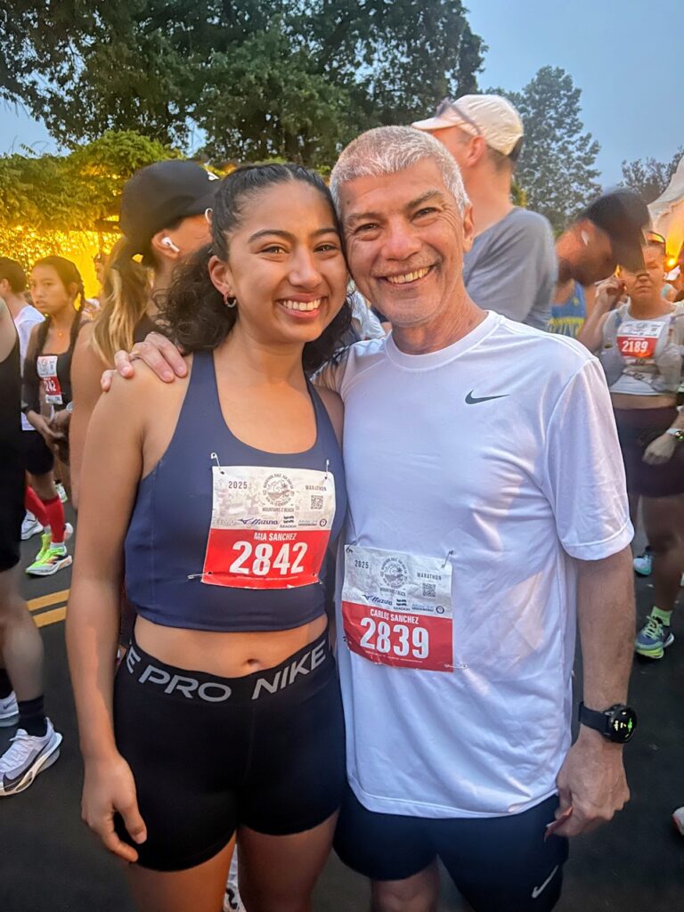 Mia and Carlos Sanchez smile at the California Marathon where they both qualified for the Boston race.