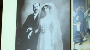 A black and white photo of two people dressed in wedding attire.