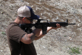 A man aims an AR-15 gun